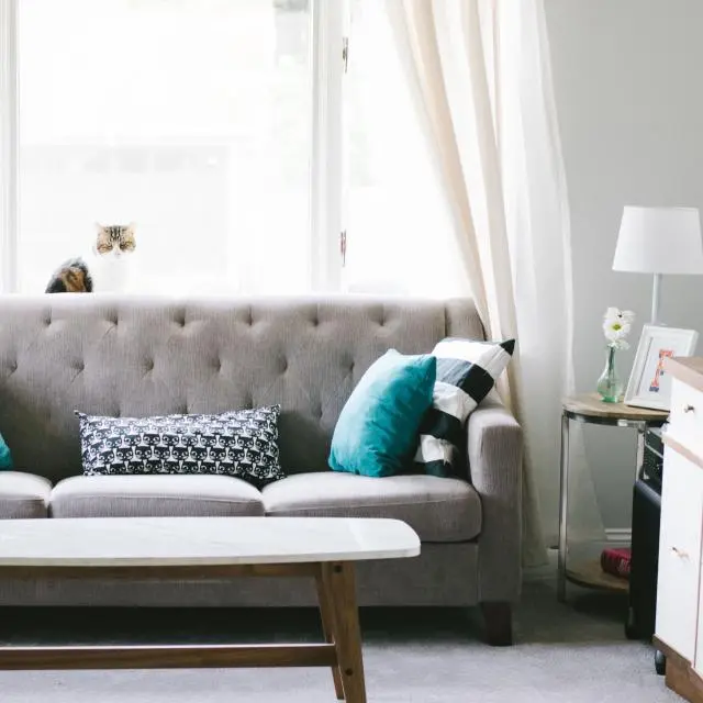 Grey tufted three-seater sofa