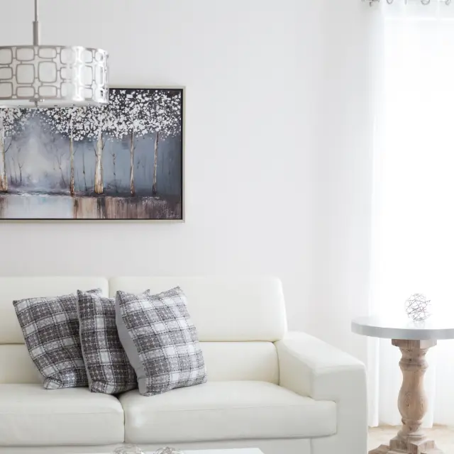 White leather-look two-seater sofa