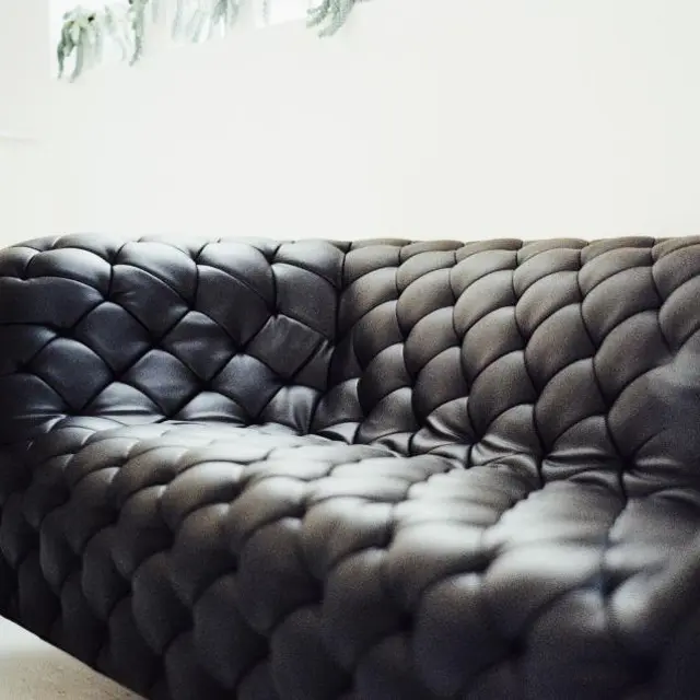 Black quilted leather-look sofa