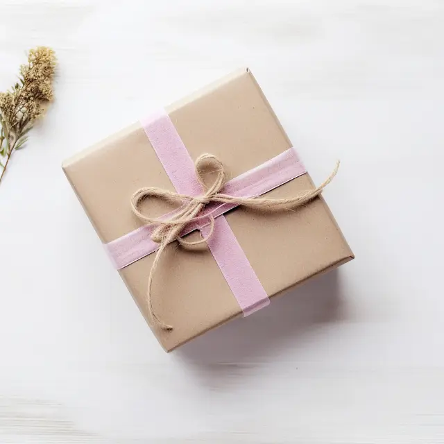 Kraft gift box with pink ribbon
